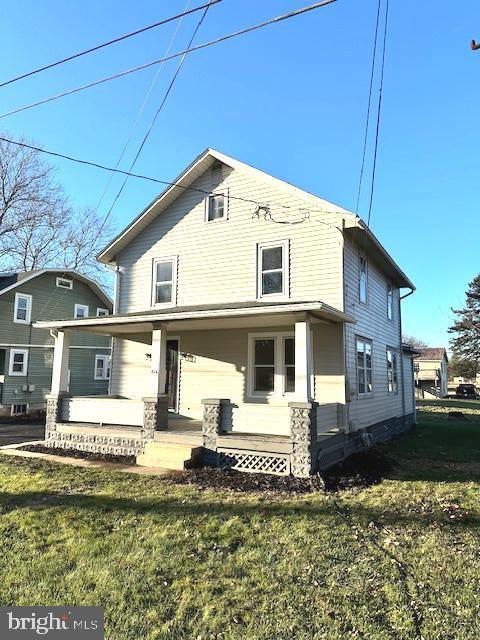 back of house with a lawn and a porch