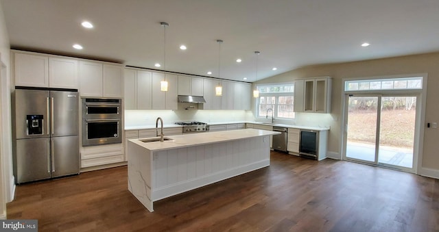 kitchen with white cabinets, decorative light fixtures, stainless steel appliances, and sink