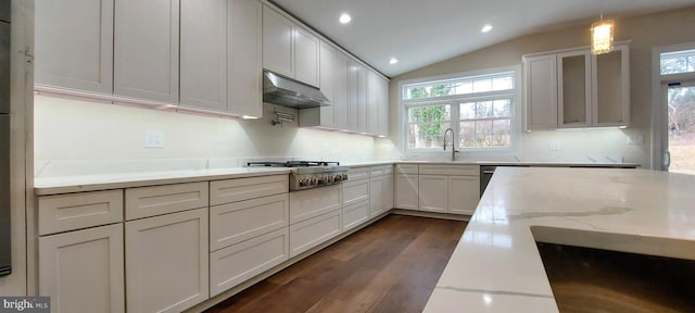 kitchen with light stone counters, vaulted ceiling, pendant lighting, white cabinetry, and stainless steel gas stovetop