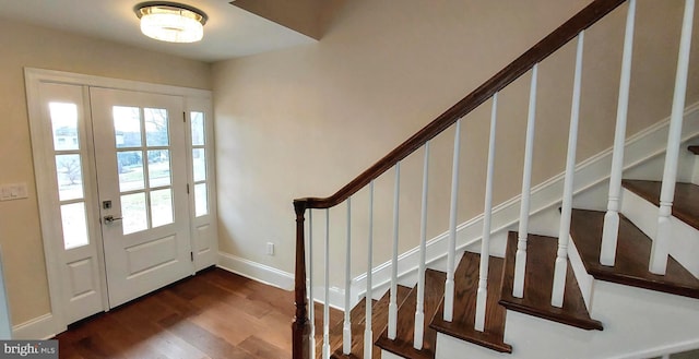 entryway with a healthy amount of sunlight and dark hardwood / wood-style flooring