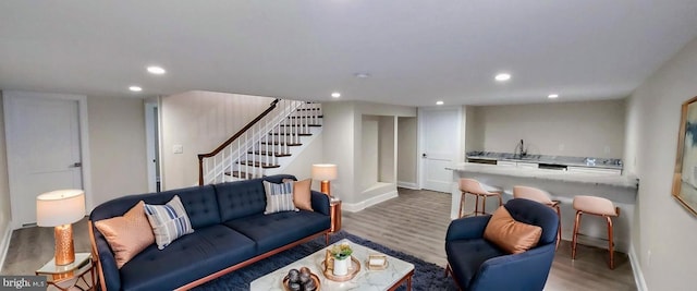 living room with wood-type flooring and sink