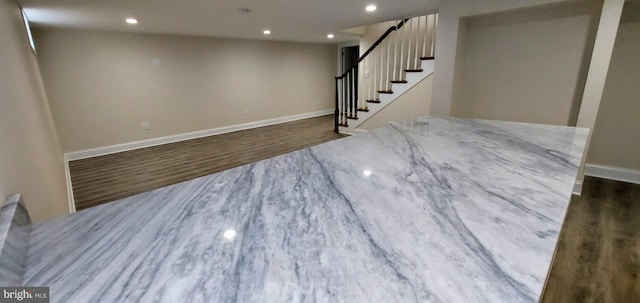 basement featuring dark hardwood / wood-style flooring