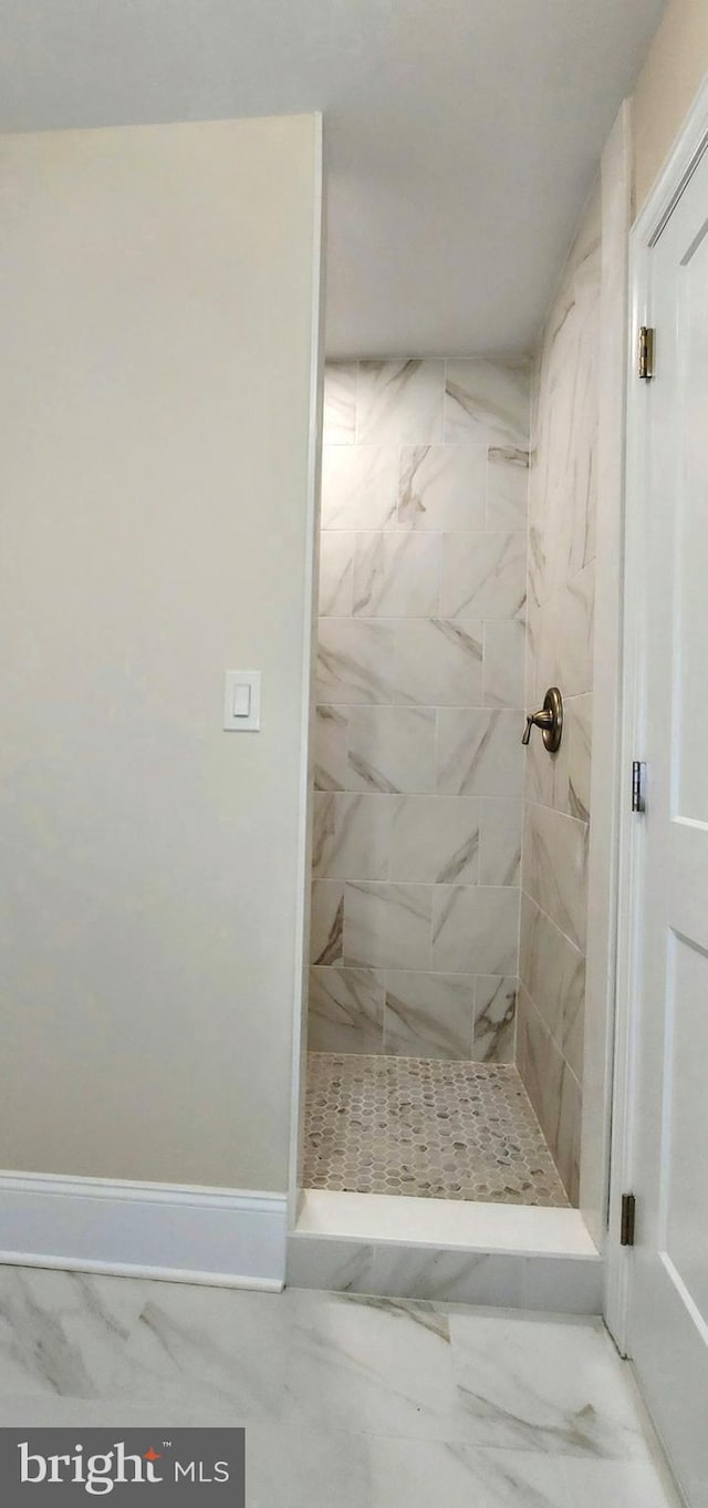 bathroom with tiled shower