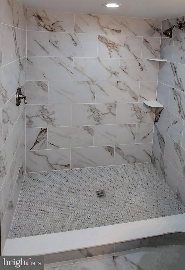 bathroom with a tile shower