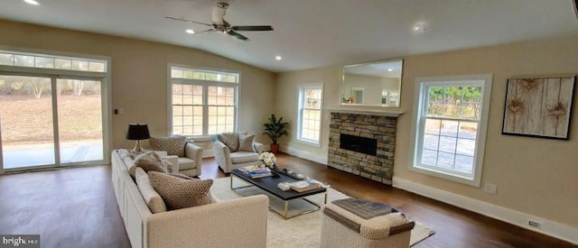 living room featuring dark hardwood / wood-style floors, ceiling fan, a fireplace, and vaulted ceiling