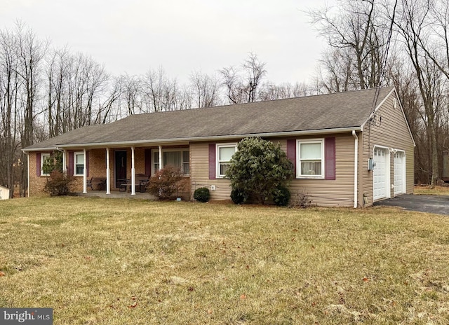 single story home featuring covered porch, a garage, and a front yard