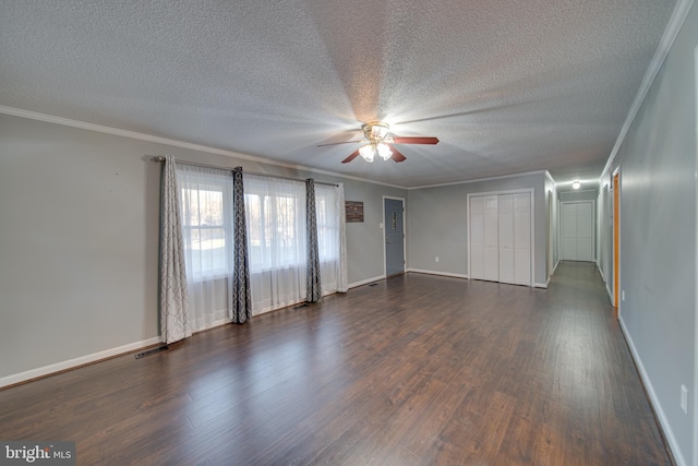 unfurnished room with a textured ceiling, ceiling fan, dark hardwood / wood-style floors, and crown molding