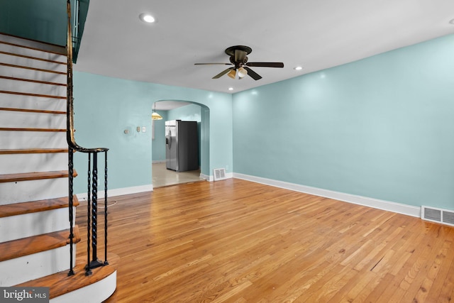 unfurnished living room featuring light hardwood / wood-style floors and ceiling fan