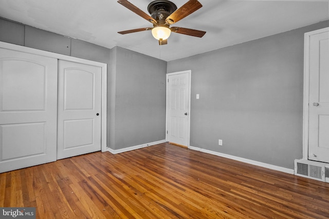 unfurnished bedroom featuring a closet, ceiling fan, and hardwood / wood-style floors