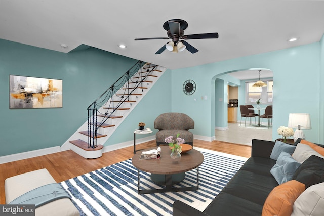 living room featuring ceiling fan and wood-type flooring