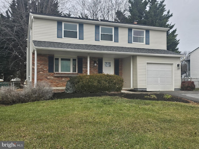 view of property featuring a garage and a front yard