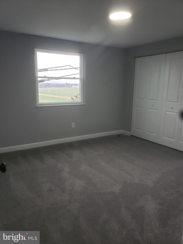 unfurnished bedroom featuring a closet and carpet