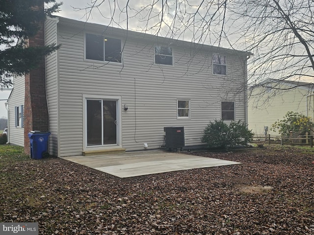 back of property with cooling unit and a patio area