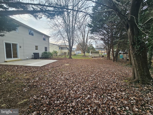 view of yard with a patio and central AC