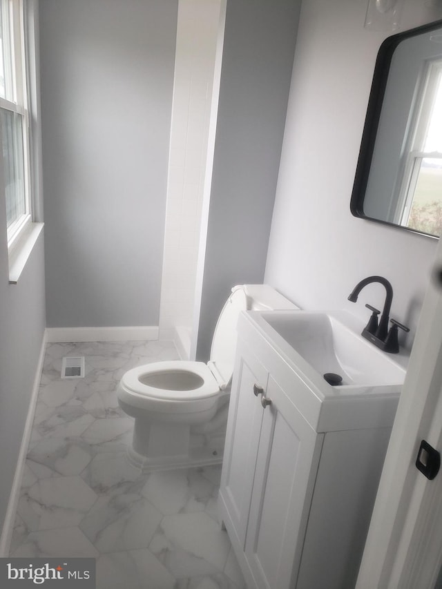 bathroom featuring vanity and toilet