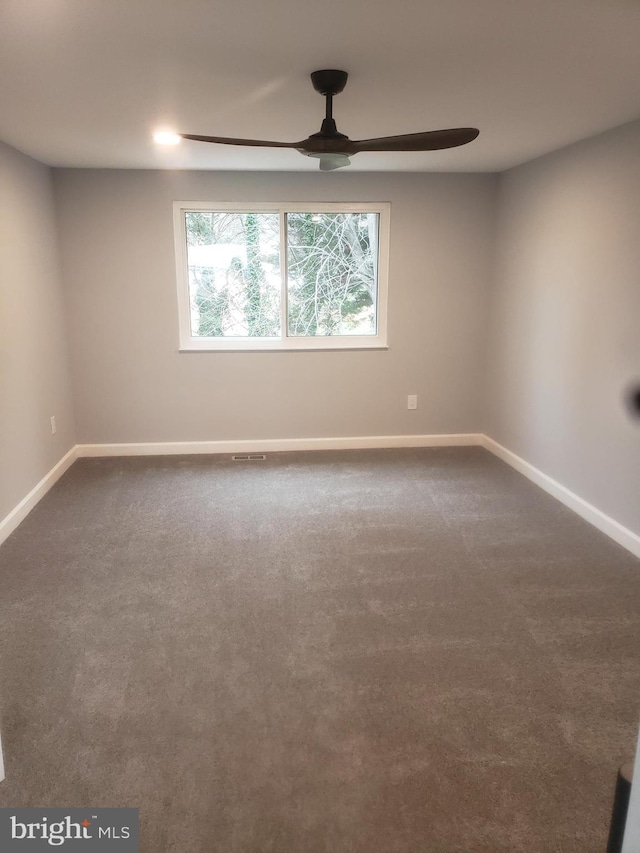 spare room featuring carpet and ceiling fan