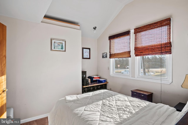 bedroom featuring lofted ceiling and carpet floors