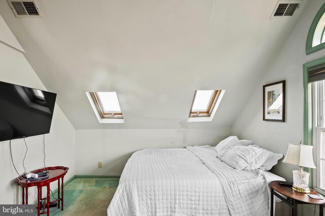 bedroom featuring dark colored carpet and vaulted ceiling