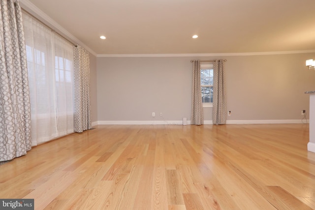 spare room with crown molding and light hardwood / wood-style floors