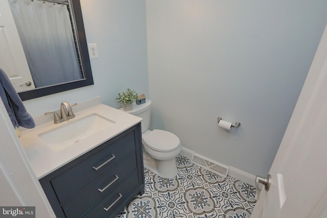 bathroom with tile patterned floors, toilet, and vanity