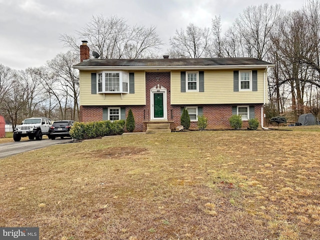 bi-level home with a front lawn