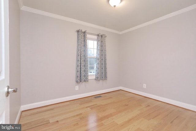 unfurnished room with ornamental molding and hardwood / wood-style flooring