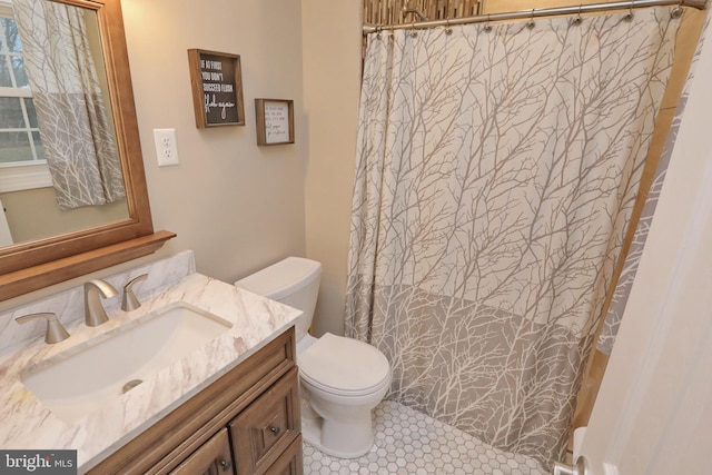 bathroom with toilet, vanity, and curtained shower