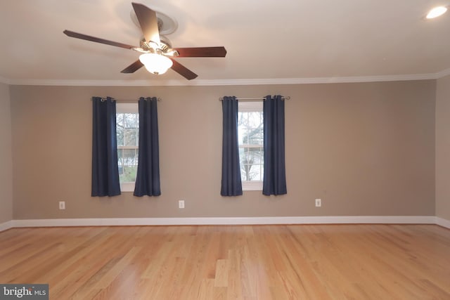 spare room with light wood-type flooring, a wealth of natural light, ornamental molding, and ceiling fan