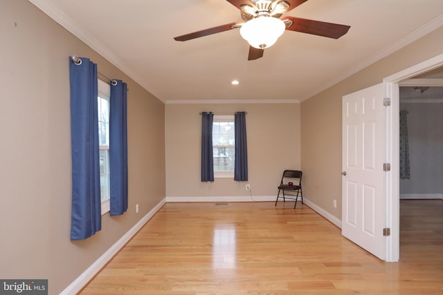 unfurnished room with ceiling fan, crown molding, and light wood-type flooring