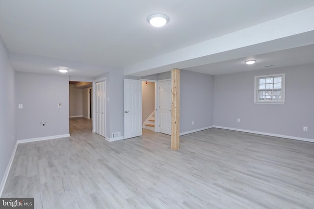 basement with light hardwood / wood-style floors