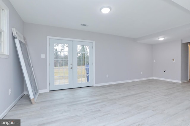 interior space with light wood-type flooring and french doors