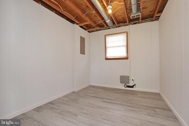 basement with light hardwood / wood-style flooring