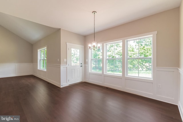 interior space featuring lofted ceiling, dark wood-type flooring, and a chandelier