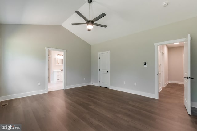 unfurnished bedroom with lofted ceiling, ceiling fan, ensuite bathroom, and dark hardwood / wood-style floors