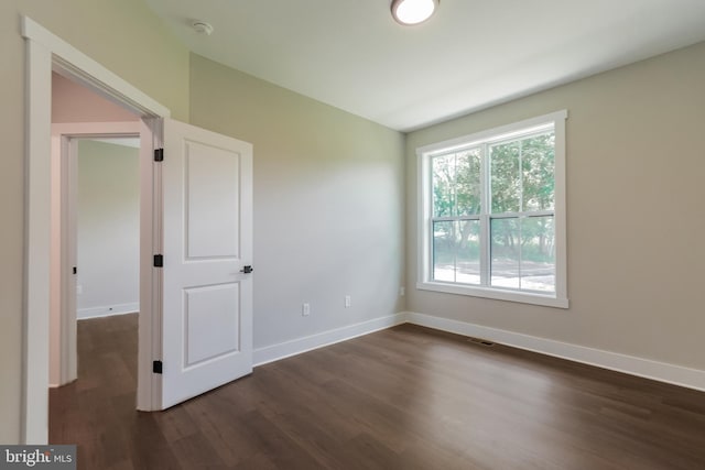 spare room with dark hardwood / wood-style flooring