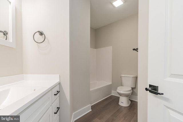 bathroom with vanity, hardwood / wood-style flooring, and toilet