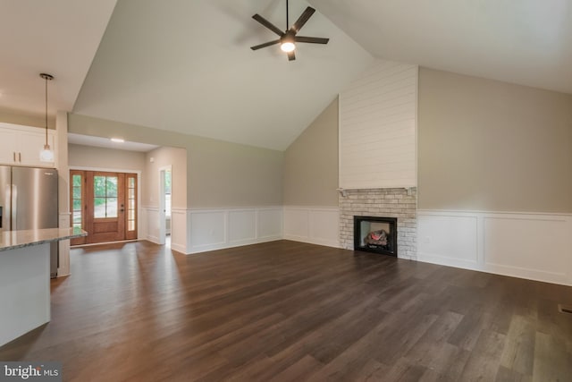 unfurnished living room with ceiling fan, a fireplace, high vaulted ceiling, and dark wood-type flooring