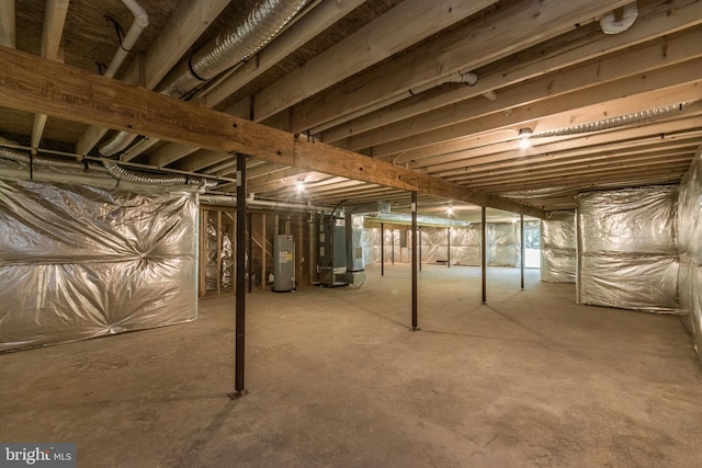 basement featuring gas water heater and heating unit