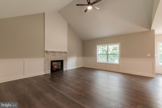 unfurnished living room featuring a fireplace, ceiling fan, dark hardwood / wood-style flooring, and high vaulted ceiling