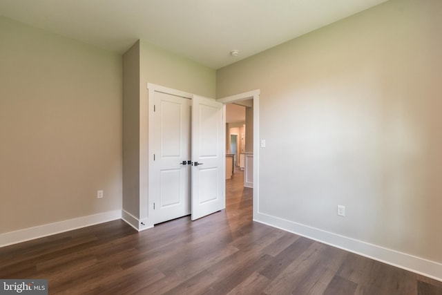 unfurnished bedroom featuring dark hardwood / wood-style flooring