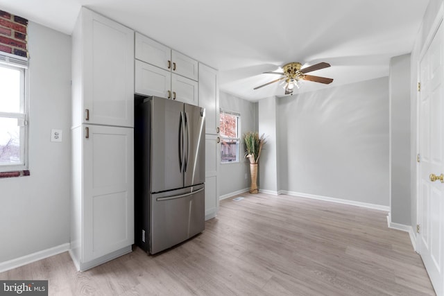 kitchen featuring stainless steel fridge, light hardwood / wood-style floors, white cabinetry, and ceiling fan