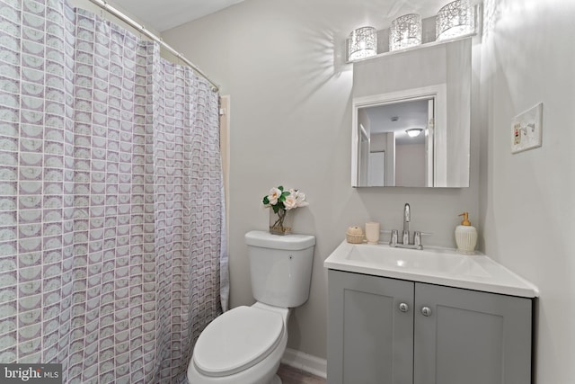 bathroom featuring vanity, a shower with shower curtain, and toilet