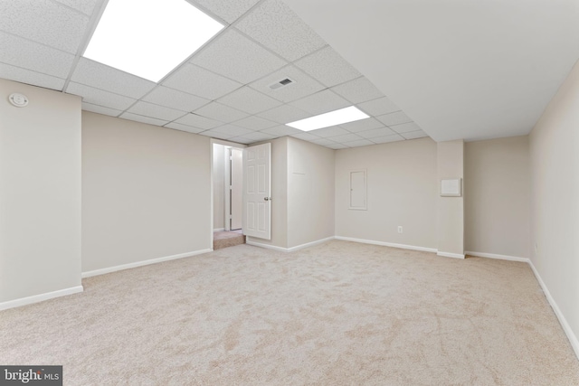 basement with light carpet and a drop ceiling