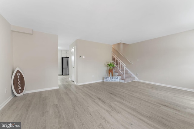 unfurnished living room with light wood-type flooring