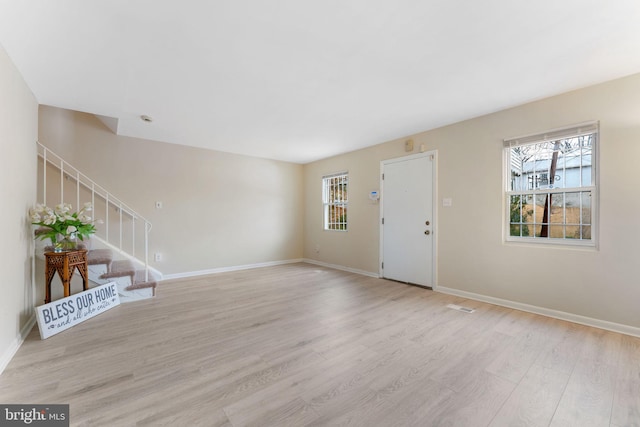 interior space with plenty of natural light and light hardwood / wood-style floors