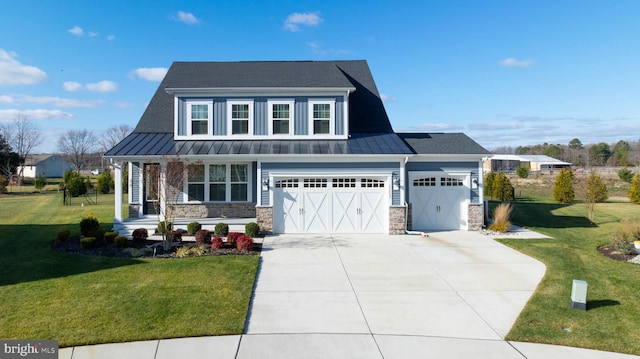 view of front facade with covered porch, a front lawn, and a garage