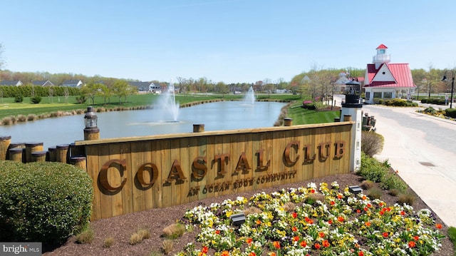 community / neighborhood sign with a water view