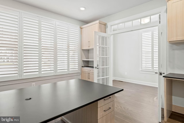 kitchen featuring hardwood / wood-style flooring and light brown cabinets