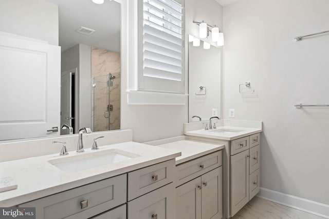 bathroom with tiled shower and vanity