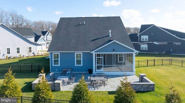 back of house with a lawn, a sunroom, and a patio area